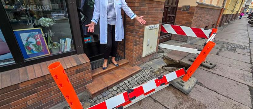 „Przeskakuję przez barierki, żeby wejść do pracy”. Czekają cztery miesiące na naprawę zapadliska